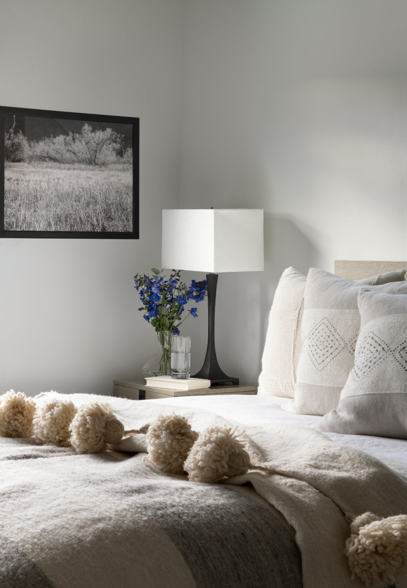 Guest bedroom with decorated bed and end table
