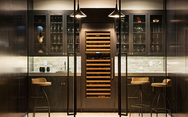 Elegant luxury wine cellar with countertop and barstools