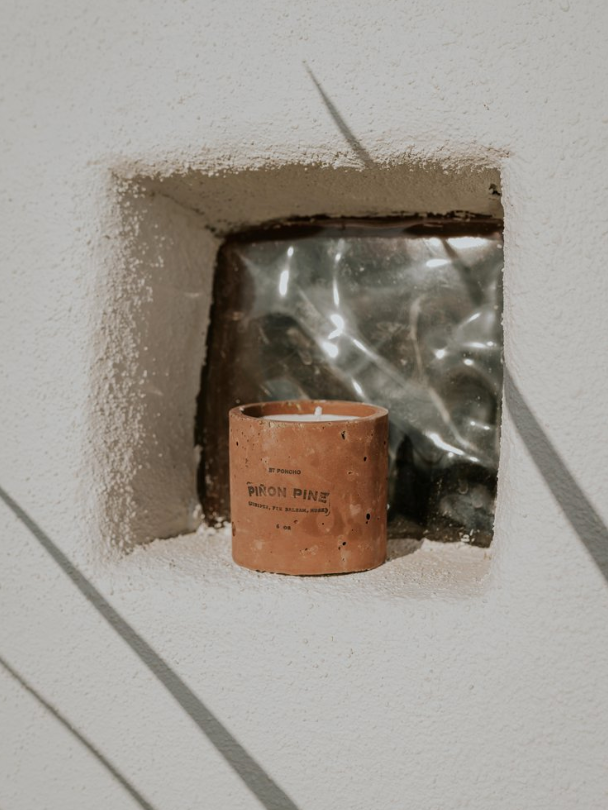 Piñon Pine candle in concrete windowsill
