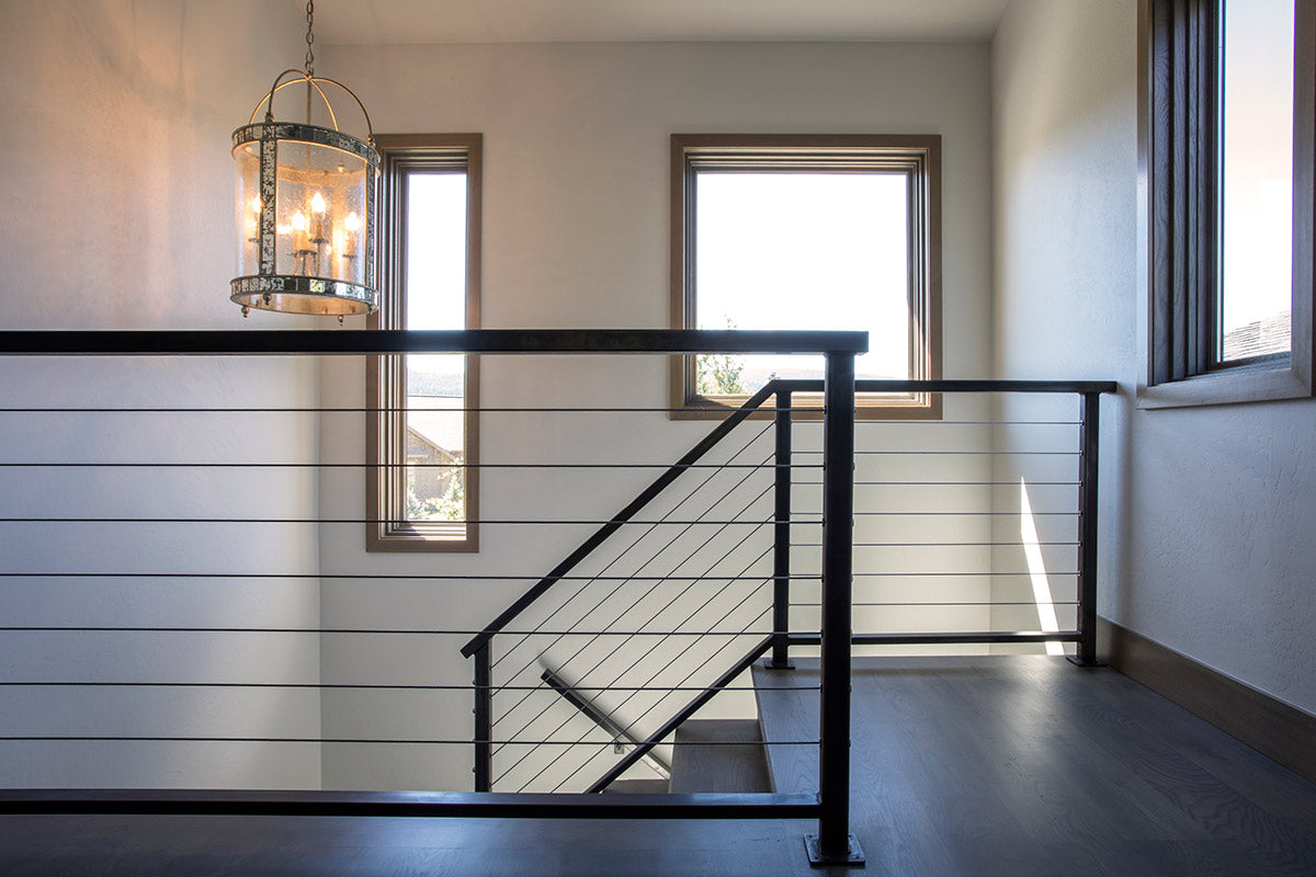 Modern staircase with antique light fixture