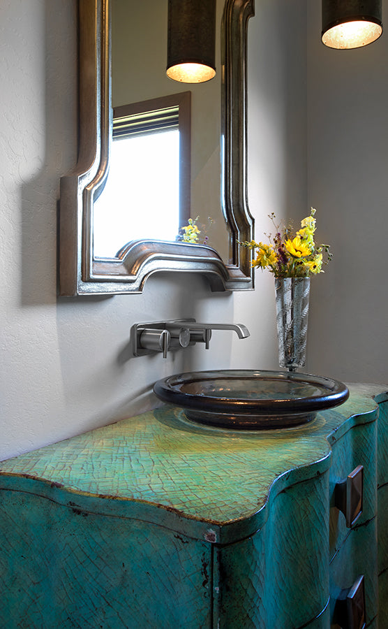 Antique bathroom vanity with basin sink and ornate mirror