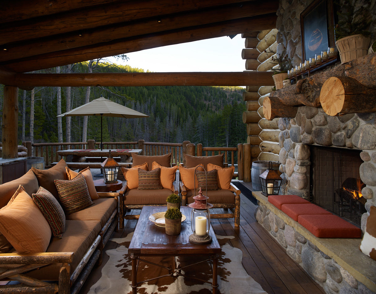 Exterior porch with massive stone fireplace and beautiful mountain views