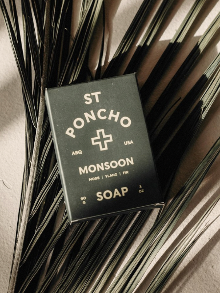 Saint Poncho monsoon hand soap bar in packaging on a palm leaf