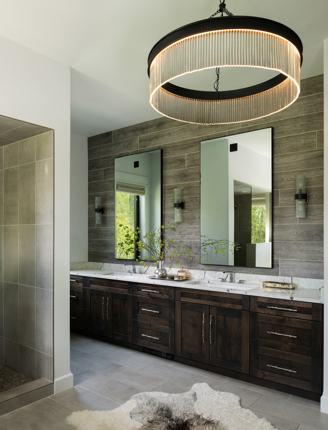 Transitional bathroom with rustic cabinets, modern lighting