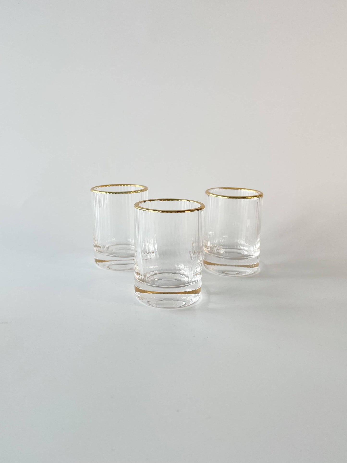 Short gold rimmed shot glasses