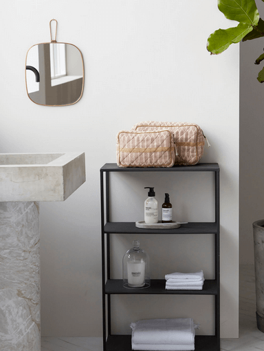 Terracotta and sand makeup and toiletry bags in bathroom