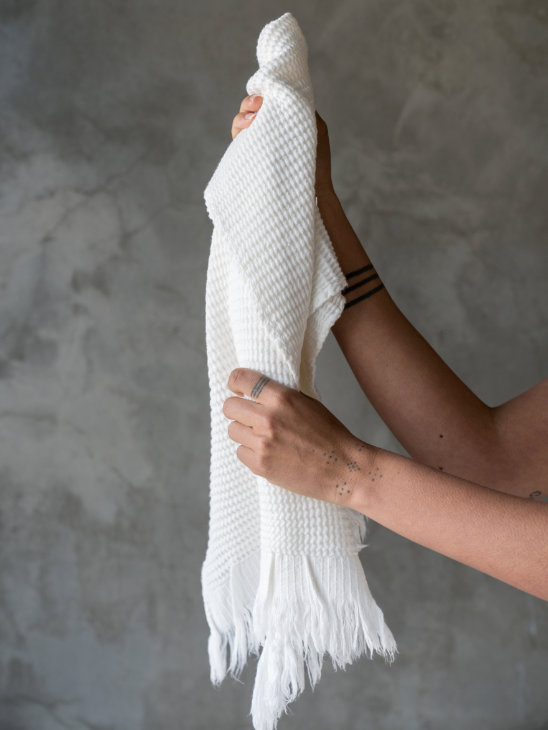 Person holding white hand towel