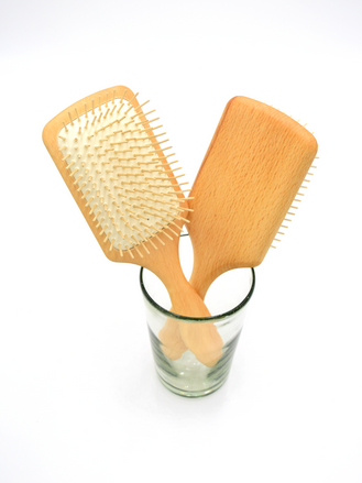 Wooden paddle brushes in glass